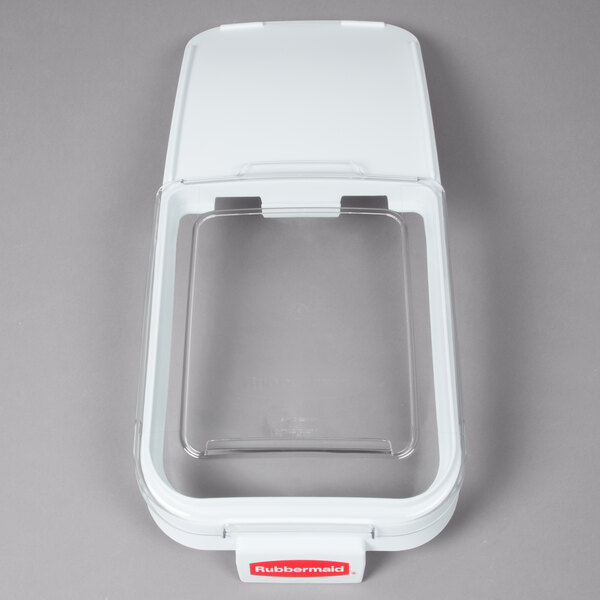 A clear plastic lid with a scoop hook for a white Rubbermaid® container.