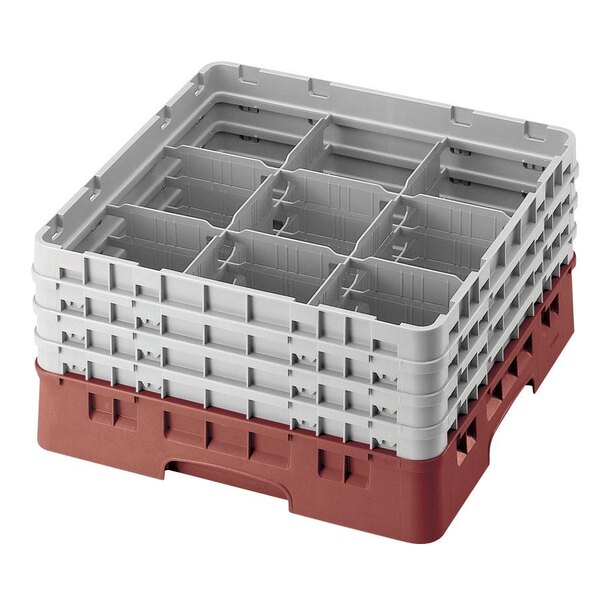 A red and white plastic Cambro glass rack with 9 compartments and 3 extenders.