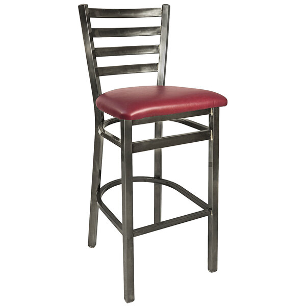 A BFM Seating metal bar height chair with a burgundy vinyl seat