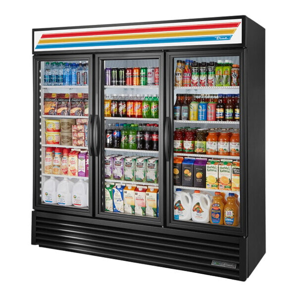 A True black refrigerated glass door merchandiser filled with drinks and beverages.