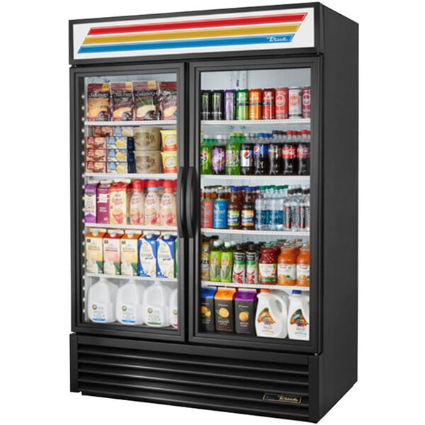 A True black refrigerated glass door merchandiser full of drinks and beverages.