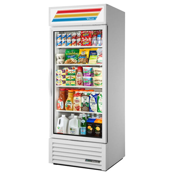A True white refrigerated glass door merchandiser full of food and drinks.
