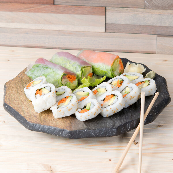 A 10 Strawberry Street Whittier Nagoya stoneware platter with sushi on a wood surface.