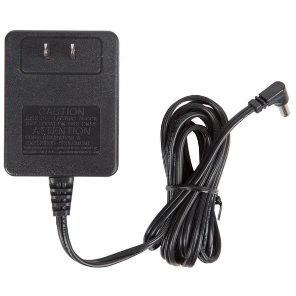 A black Cardinal Detecto 12V AC adapter with a cord attached.