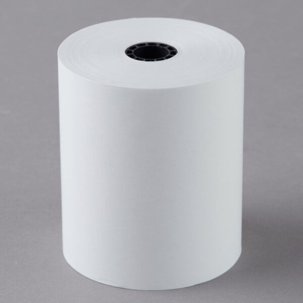 A white roll of Point Plus thermal cash register paper on a white surface.
