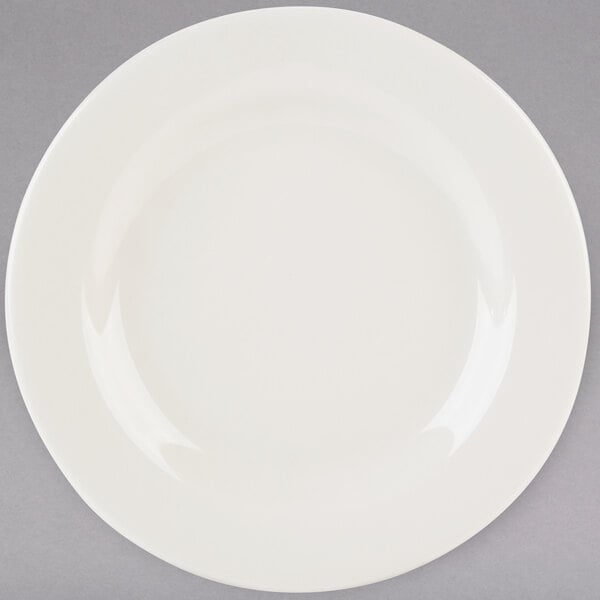 A Tuxton Reno ivory china plate with a wide white rim.