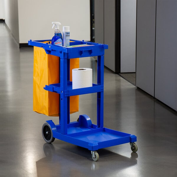 A Lavex blue janitor cart with a yellow bag on it.