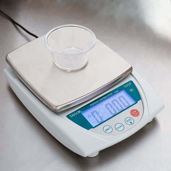 A clear plastic cup on a Taylor Precision digital portion scale.