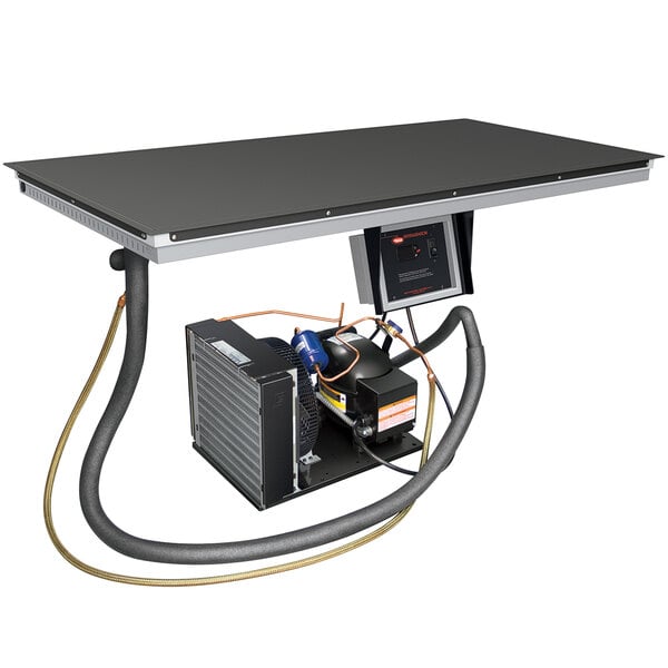 A black table with a Hatco Built-In Top-Mount Cold Shelf on it.