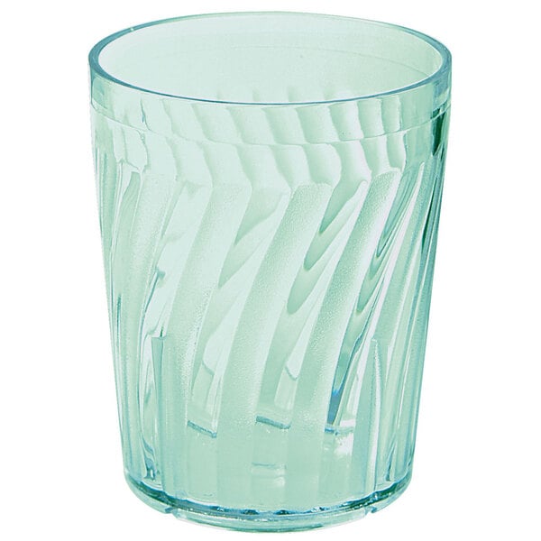 A clear plastic tumbler with a green wave pattern on it.