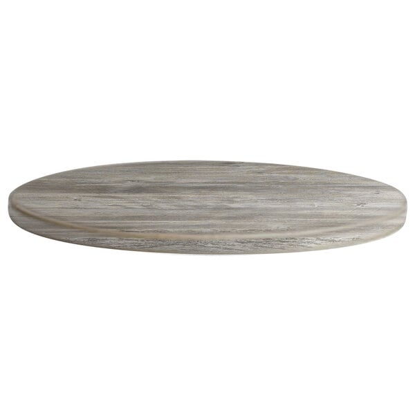 A Grosfillex VanGuard round wooden table top with a grey finish.