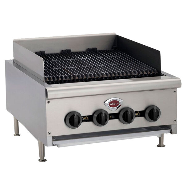 A Wells heavy duty natural gas charbroiler with four stainless steel burners and black metal grates.
