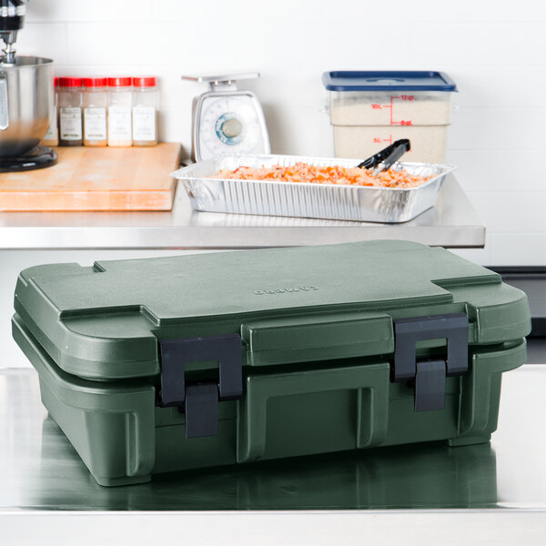 A granite green Cambro insulated food pan carrier on a counter.