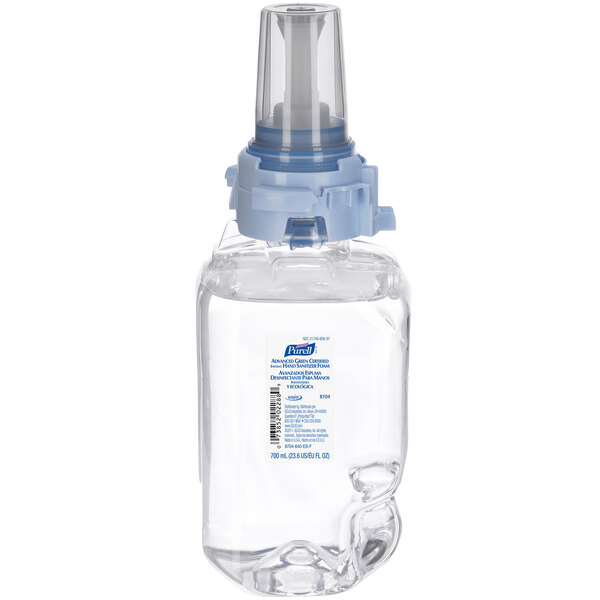 A clear plastic bottle with a blue cap of Purell foaming hand sanitizer.