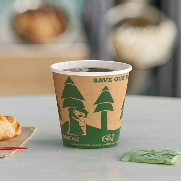 A close-up of an EcoChoice Kraft paper hot cup of coffee on a table with a croissant.