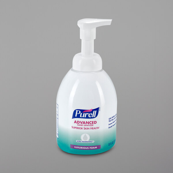 A close up of a white and blue Purell foaming hand sanitizer bottle with a pump.
