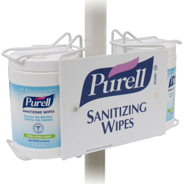 A white Purell sanitizing wipes pole-mount bracket with a label.