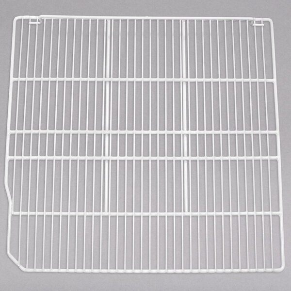 A close-up of a white metal grid shelf.