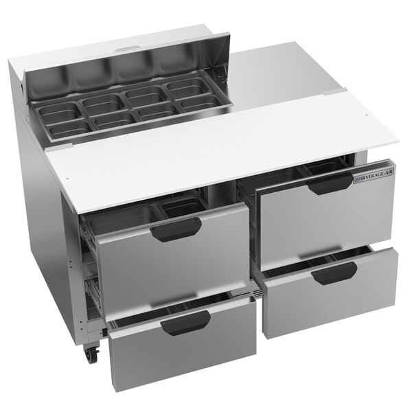 A Beverage-Air stainless steel commercial kitchen refrigerator with four drawers and a cutting board.