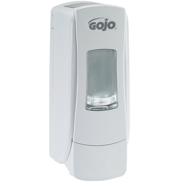A white GOJO® soap dispenser with a clear plastic cover.