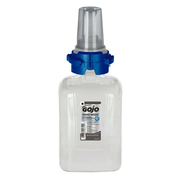 A clear plastic bottle of GOJO Hand Medic with a blue cap.