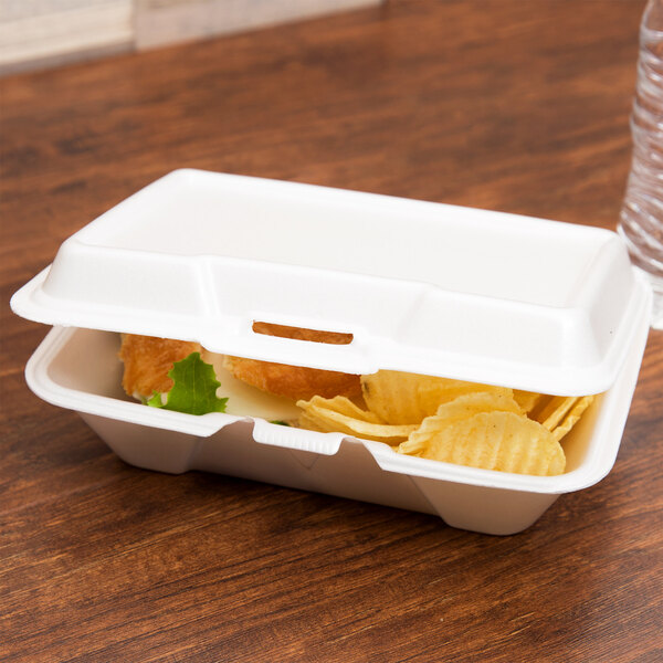 A Genpak white foam hinged lid container with food inside.