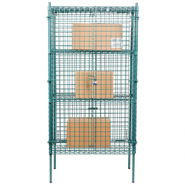 A green metal Regency security cage kit with black rectangular objects on top.