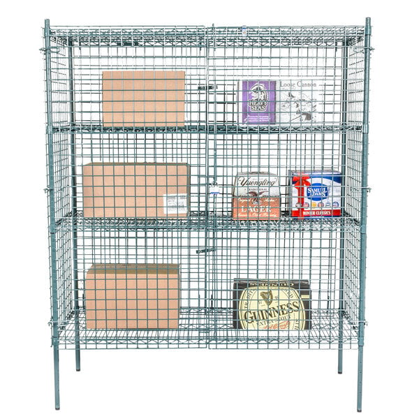 A Regency green wire security cage kit holding boxes and a shelf behind a wire fence.