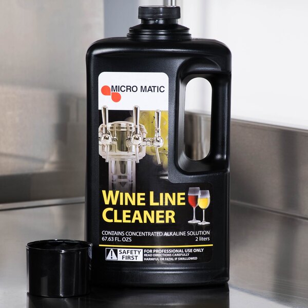 A black bottle of Micro Matic Alkaline Wine Line Cleaner with a white label.