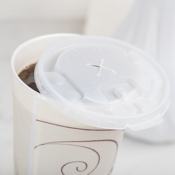 A Solo translucent plastic lid with lift and lock tab and straw slot on a coffee cup.