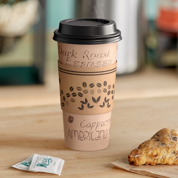 A Choice 20 oz. Kraft paper hot cup with a black lid and a sleeve on a table with coffee beans.