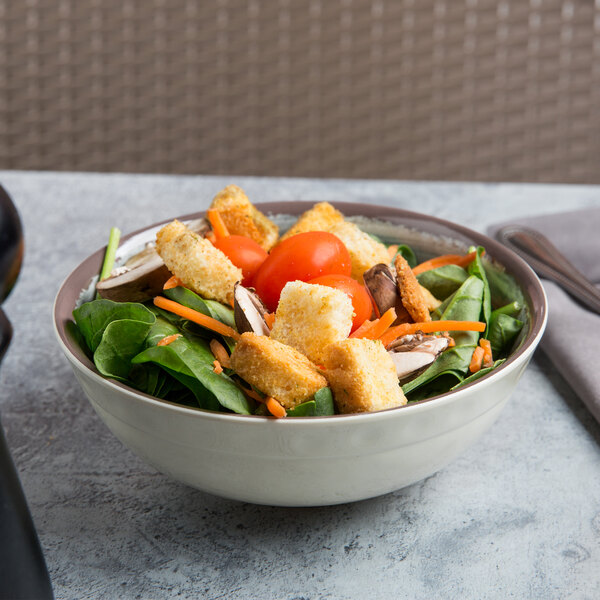 A Carlisle Smoke Melamine bowl filled with salad with croutons and mushrooms.