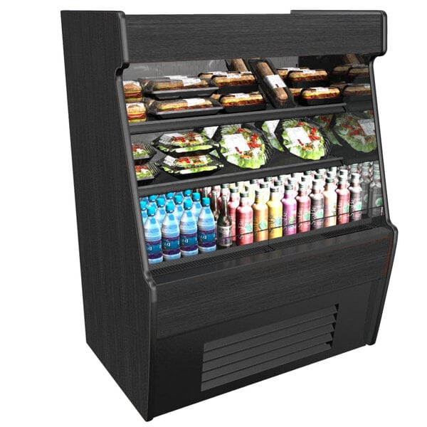 A black Structural Concepts Oasis air curtain merchandiser with food and drinks on shelves.