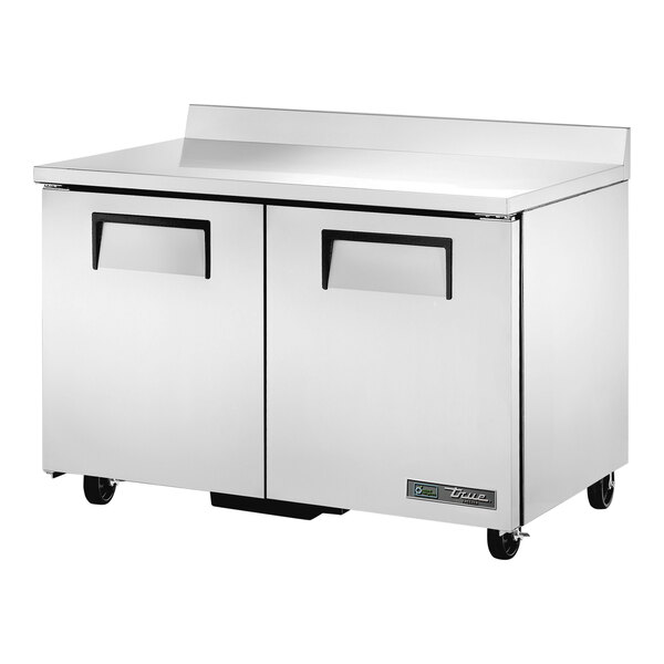 A True worktop freezer with a stainless steel top and two doors on wheels.