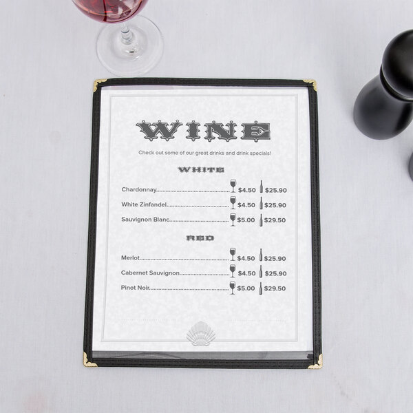 A blue menu with a shell border on a table with a glass of wine.