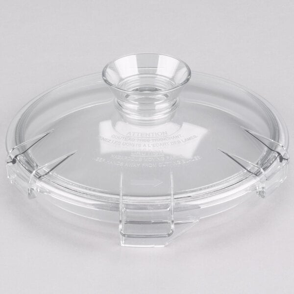A clear plastic lid with a clear rim and handle over a clear glass bowl.