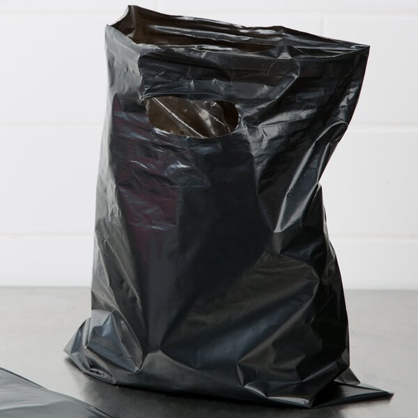 A black plastic Choice merchandise bag with a hole in it.