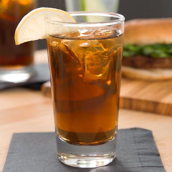 A Libbey Diplomat highball glass of iced tea with a lemon wedge.