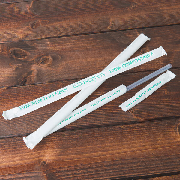 A group of Eco-Products clear wrapped straws with green and white writing.