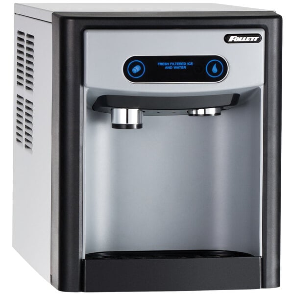 A white Follett 7 Series countertop ice and water dispenser with blue buttons and a screen.