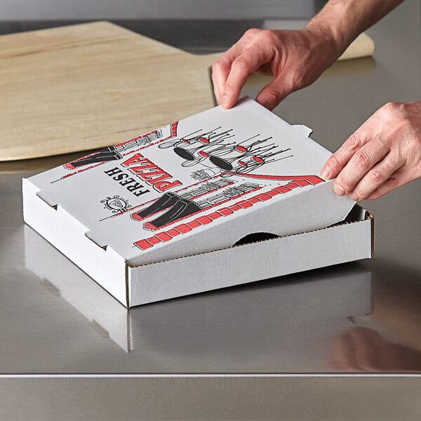 A hand opening a Choice white corrugated pizza box on a table.