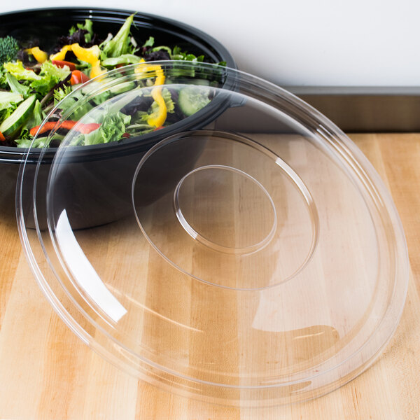 A Fineline clear plastic lid on a bowl of salad.