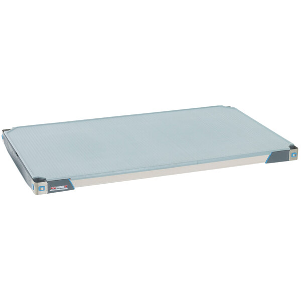 A white rectangular shelf with blue solid mats.