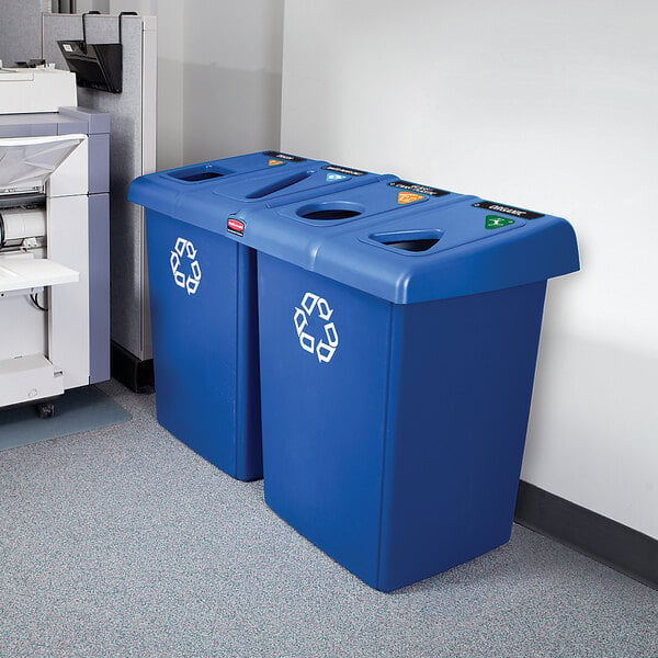 A Rubbermaid blue rectangular recycling station for Glutton recycling bins in a corporate cafeteria.