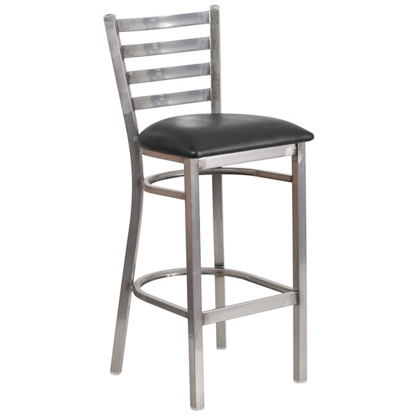 A clear-coated metal restaurant barstool with a black vinyl seat.