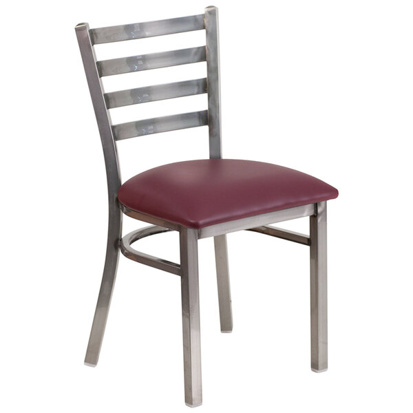 A Flash Furniture metal restaurant chair with a burgundy seat and ladder back.