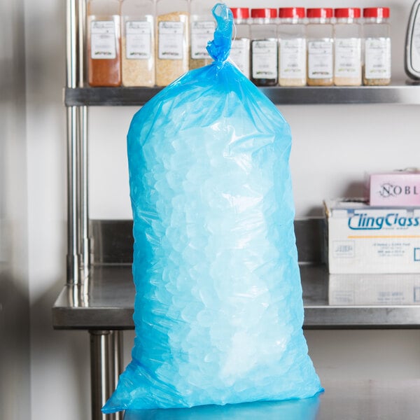 A blue plastic bag of ice on a counter.