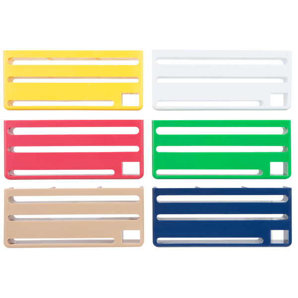 A set of four rectangular plastic cards in different colors: white, yellow, blue, and green.