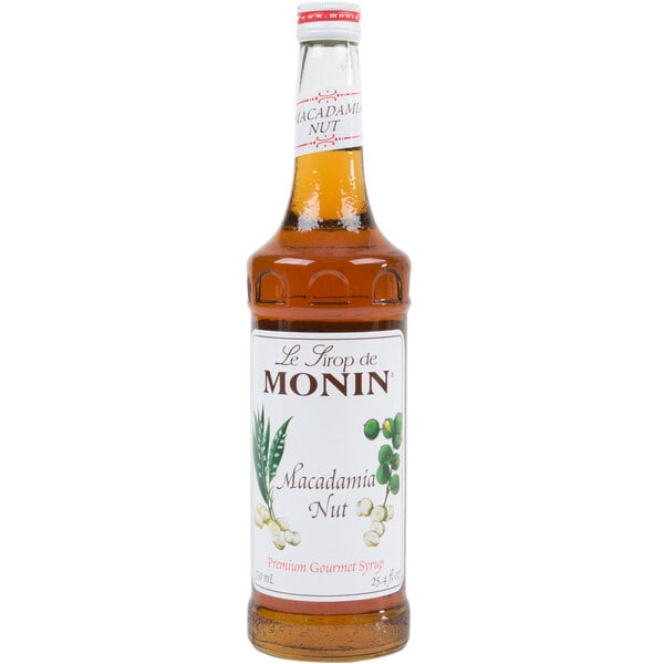 A bottle of Monin Macadamia Nut syrup with a white label.