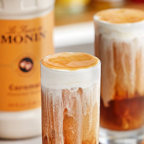Two glasses of iced coffee with Monin caramel flavoring sauce.